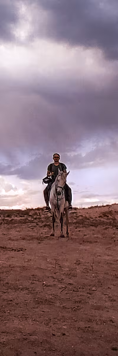 A man sitting on a horse